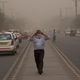 A man wraps a scarf around his nose as a dust storm envelops the city in New Delhi, India on Wednesday.